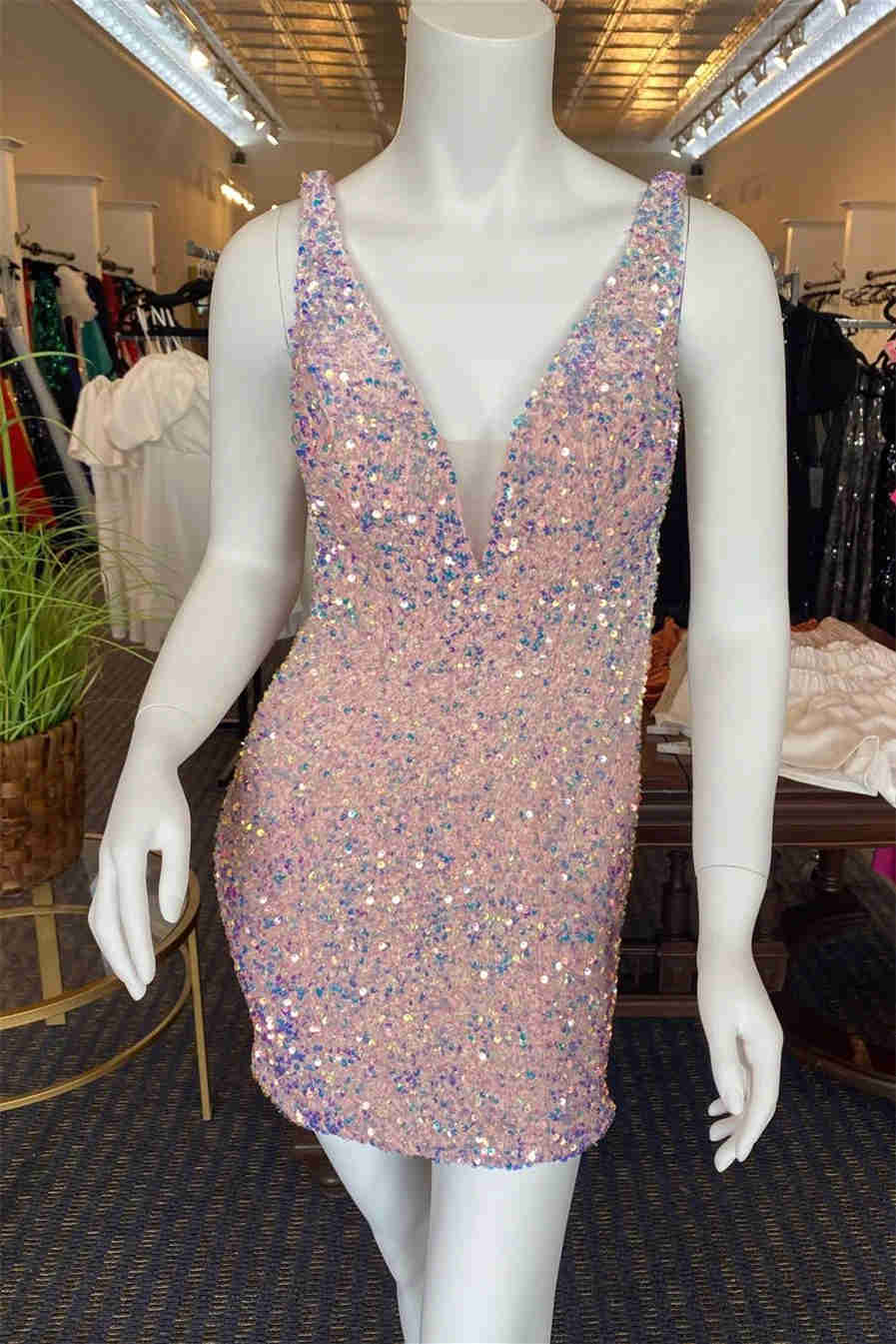 This tight short homecoming dress features hater neckline and sequins ...